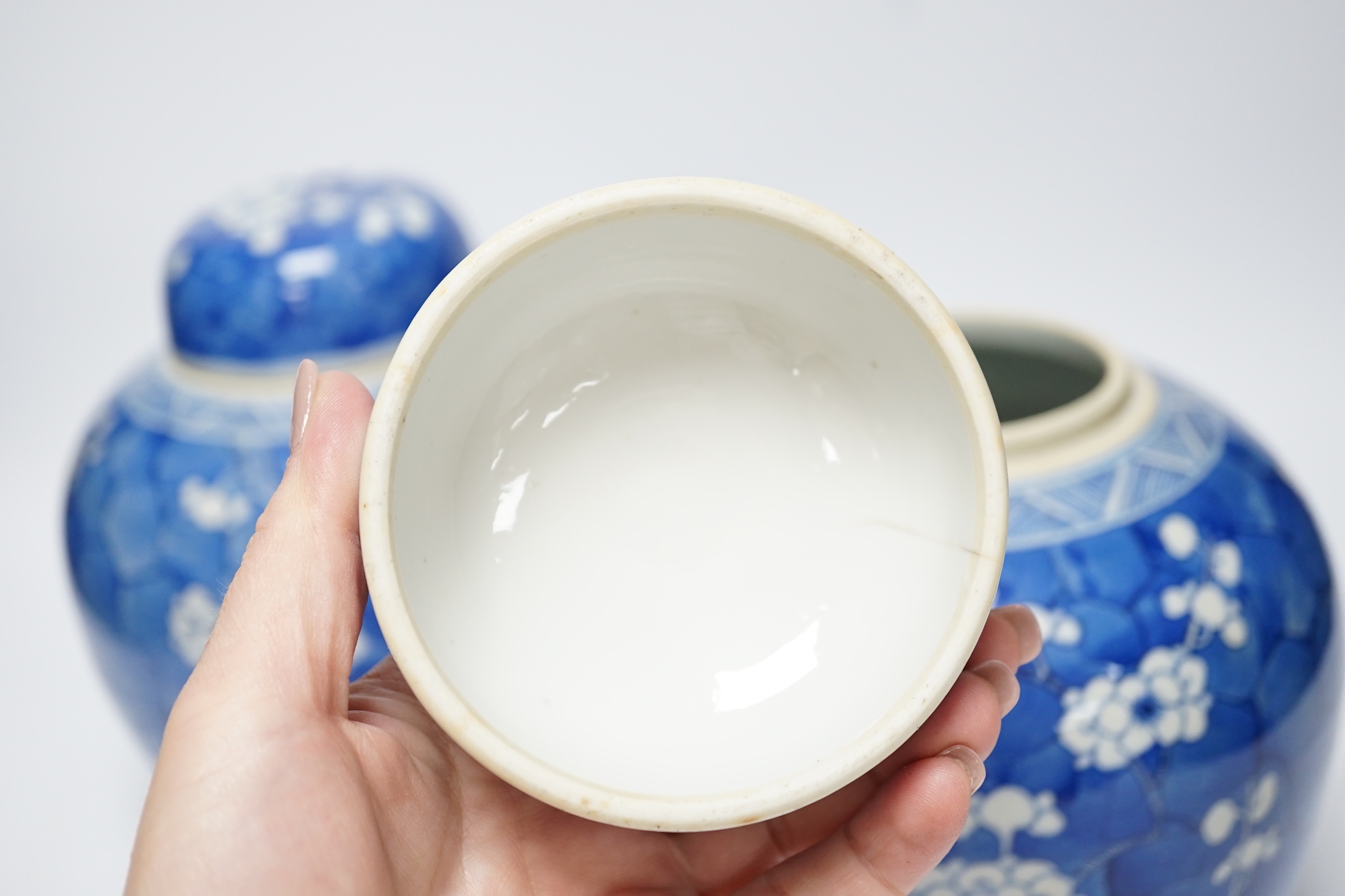 A pair of Chinese blue and white prunus jars and covers, late 19th century, 21.5cm